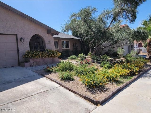 view of front facade with a garage and stucco siding