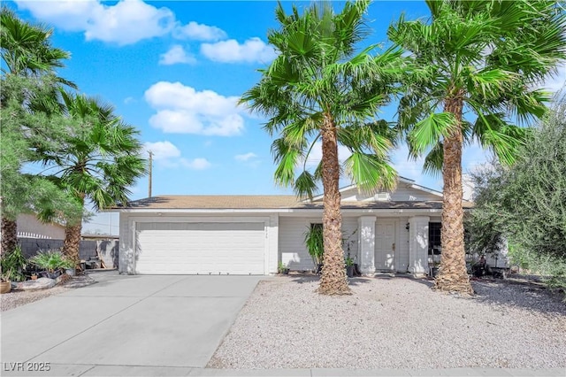 view of front facade featuring concrete driveway and an attached garage