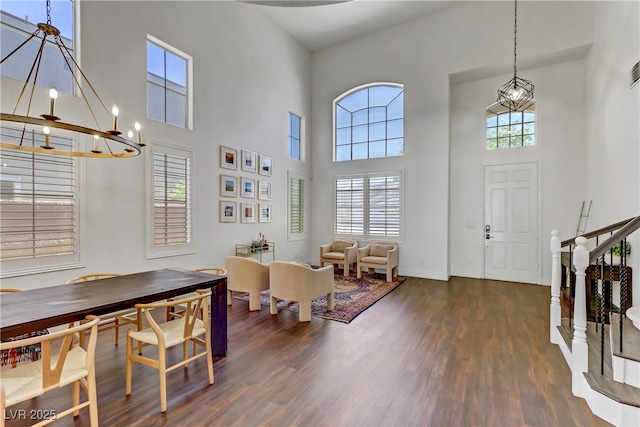 entrance foyer featuring stairs, dark wood-style flooring, baseboards, and a notable chandelier