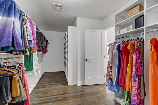 spacious closet featuring wood finished floors and visible vents