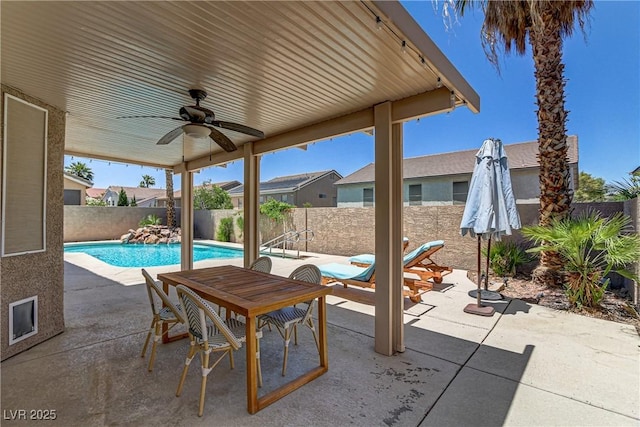 view of patio featuring a ceiling fan, outdoor dining space, a fenced in pool, and a fenced backyard