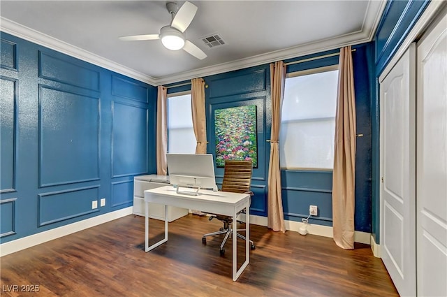 office area with ornamental molding, visible vents, a decorative wall, and dark wood-style floors