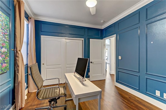 home office featuring dark wood-style floors, ornamental molding, a healthy amount of sunlight, and a decorative wall