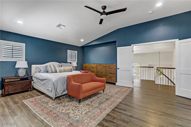 bedroom featuring lofted ceiling, dark wood-style floors, visible vents, and recessed lighting