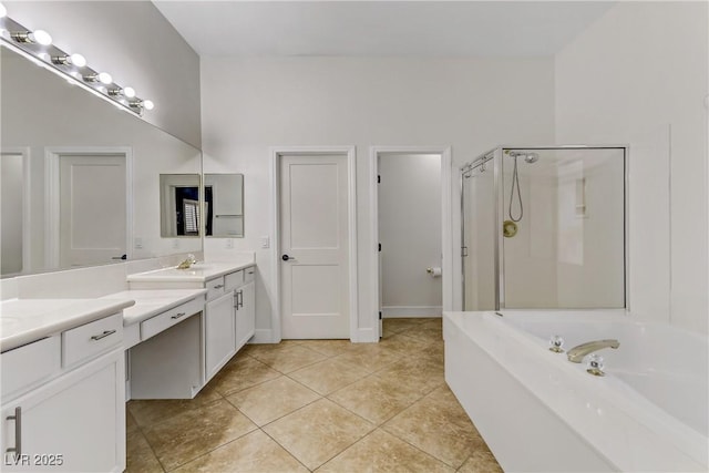 full bath with a stall shower, a garden tub, vanity, and tile patterned floors