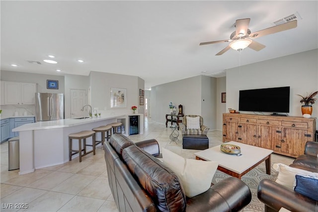 living area with light tile patterned floors, ceiling fan, visible vents, and recessed lighting