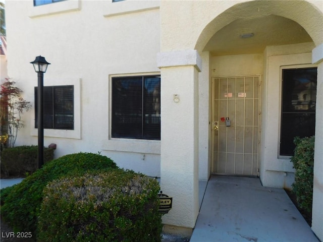 property entrance with stucco siding