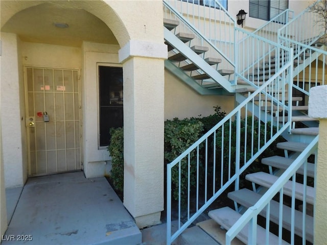 entrance to property featuring stucco siding