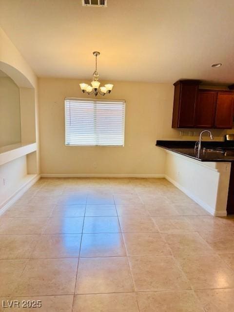 4562 White Cap Mill St, Las Vegas, NV 89147 - unfurnished dining area featuring a chandelier, light tile patterned flooring, a sink, and baseboards