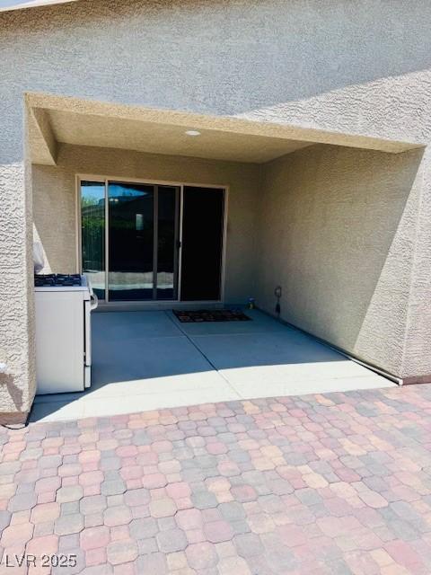 4562 White Cap Mill St, Las Vegas, NV 89147 - entrance to property with stucco siding and a patio area