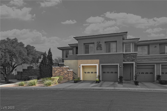 view of property featuring driveway, stone siding, an attached garage, and stucco siding