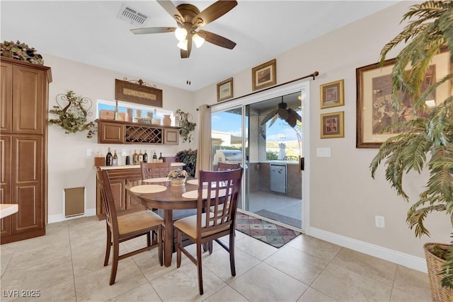 dining room featuring baseboards, visible vents, ceiling fan, and light tile patterned flooring