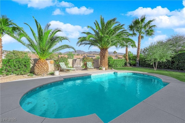 view of pool with a fenced in pool, a patio area, a fenced backyard, and a mountain view