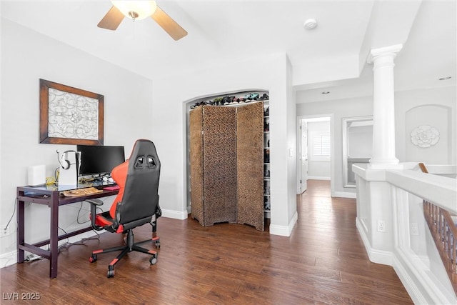 home office featuring ornate columns, baseboards, a ceiling fan, and dark wood-style flooring