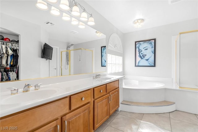 full bath featuring tile patterned flooring, visible vents, a sink, and a bath