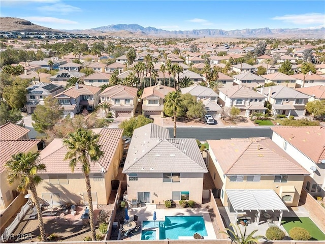 drone / aerial view featuring a residential view and a mountain view