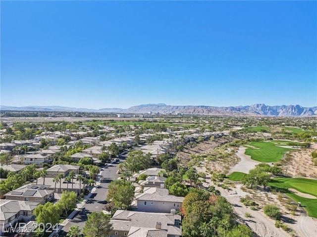 drone / aerial view featuring view of golf course, a residential view, and a mountain view