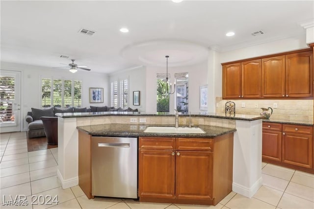 kitchen featuring visible vents, hanging light fixtures, stainless steel dishwasher, open floor plan, and dark stone counters
