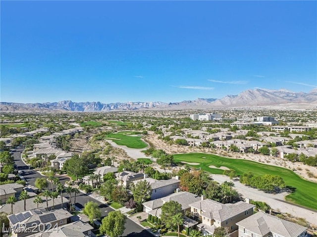 aerial view featuring view of golf course, a residential view, and a mountain view