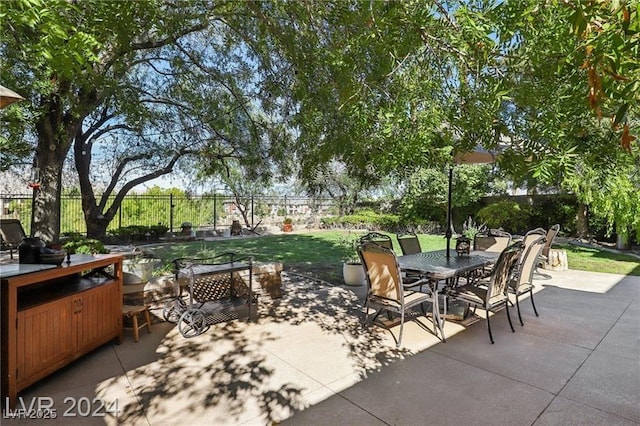view of patio / terrace featuring outdoor dining area and fence