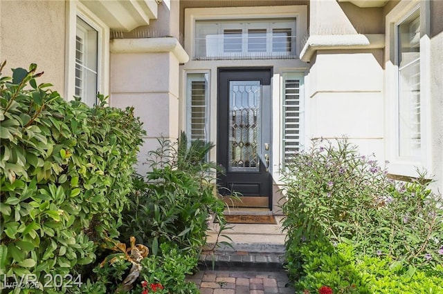 view of exterior entry featuring stucco siding