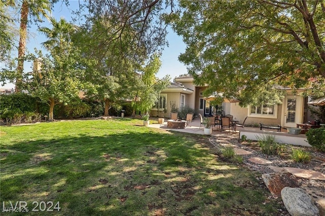 view of yard featuring a patio and an outdoor fire pit