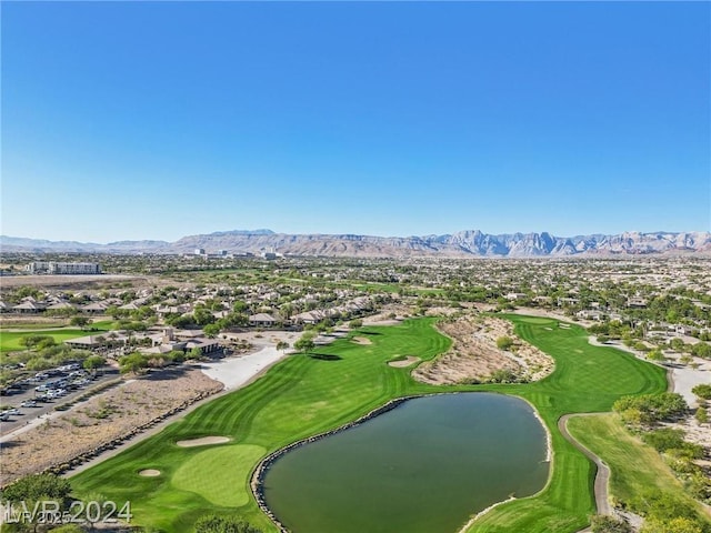 birds eye view of property featuring view of golf course and a water and mountain view