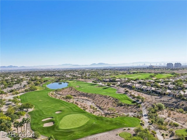 birds eye view of property with view of golf course, a view of city, and a mountain view
