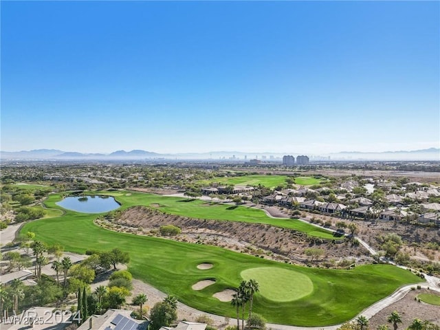 aerial view featuring golf course view, a water and mountain view, and a city view