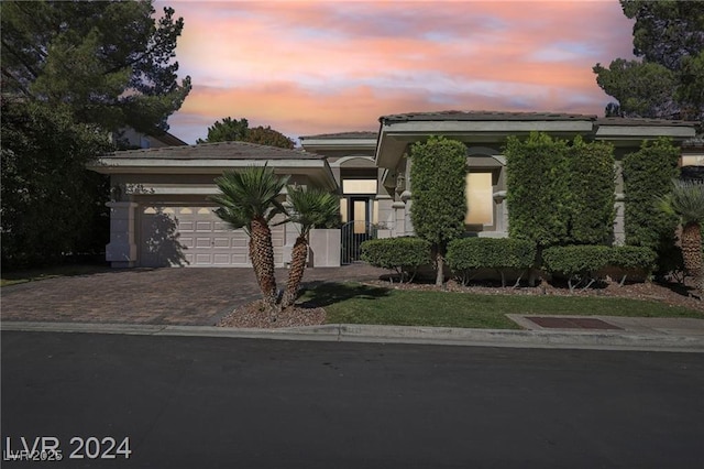 view of front of house with an attached garage and decorative driveway