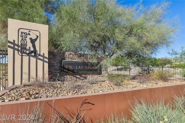 community / neighborhood sign featuring fence