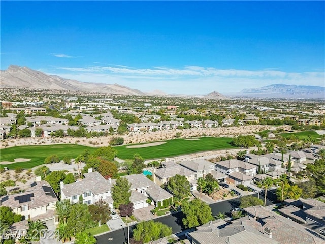 drone / aerial view featuring view of golf course, a residential view, and a mountain view