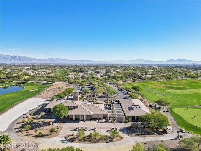 birds eye view of property with view of golf course and a water and mountain view