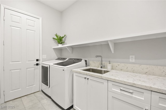 clothes washing area with washing machine and dryer, cabinet space, a sink, and light tile patterned floors