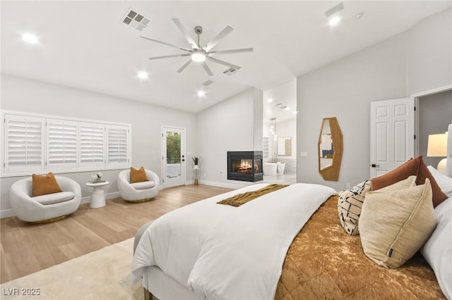 bedroom with lofted ceiling, access to exterior, light wood-style flooring, and visible vents