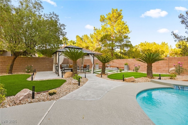 view of swimming pool featuring a fenced in pool, a lawn, a patio, a fenced backyard, and a gazebo