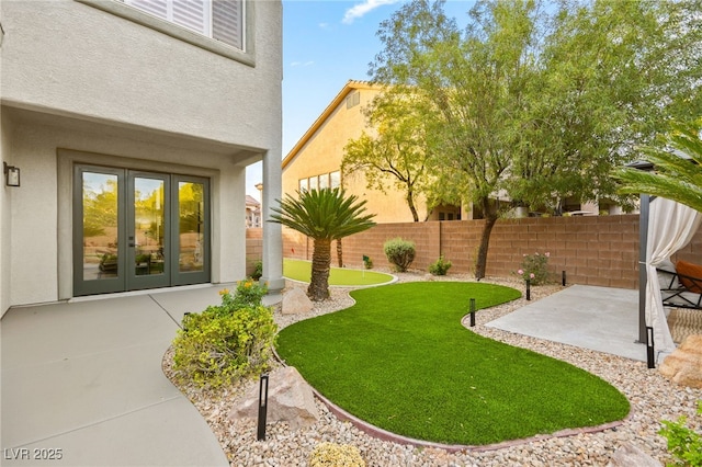 view of yard featuring french doors, a patio area, and fence private yard