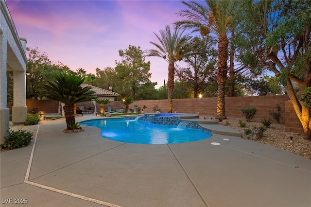 pool at dusk featuring a fenced in pool, a fenced backyard, a patio, and an in ground hot tub