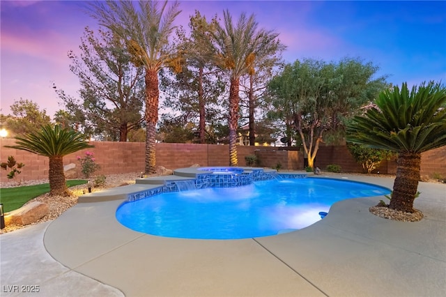 view of pool featuring a patio, a fenced backyard, and a pool with connected hot tub