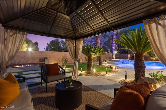 patio terrace at dusk with a fenced in pool, a fenced backyard, a gazebo, and an outdoor hangout area