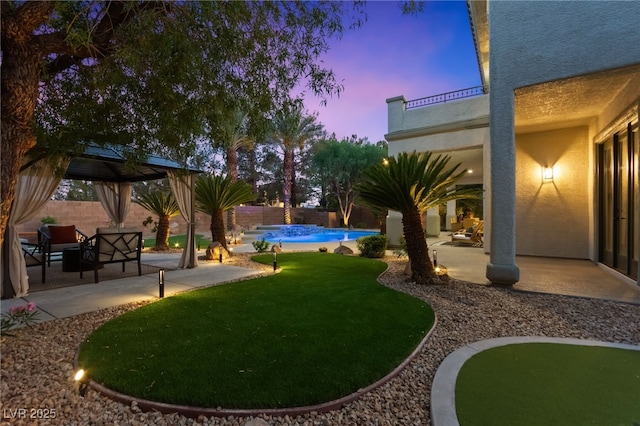 view of yard with a patio, a fenced backyard, and an outdoor pool