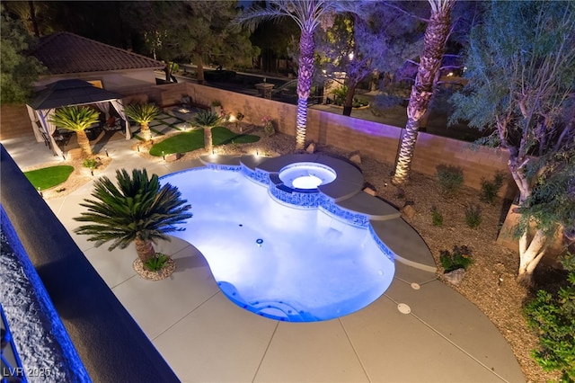 view of swimming pool featuring an in ground hot tub and a fenced backyard