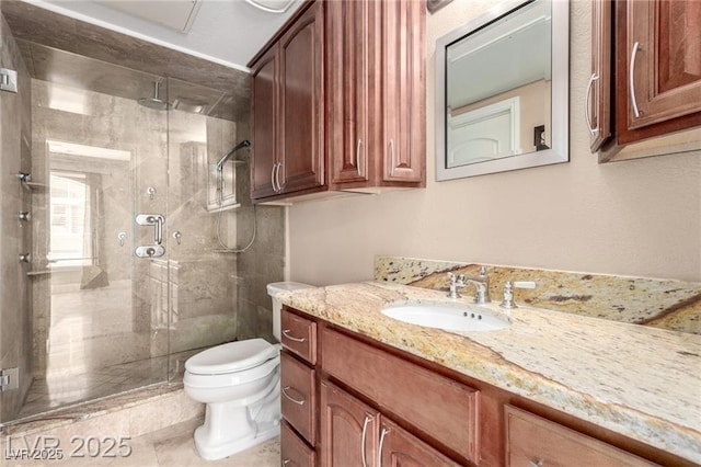 bathroom with toilet, a stall shower, and vanity