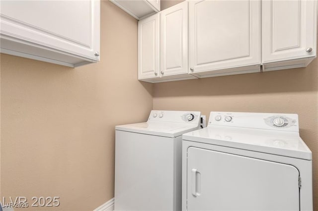 washroom featuring baseboards, cabinet space, and washer and dryer