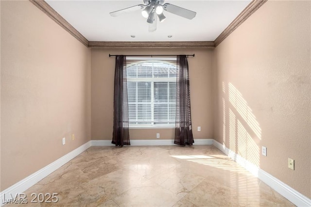 empty room with a ceiling fan, marble finish floor, crown molding, and baseboards