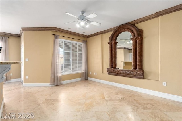 empty room featuring ceiling fan, ornamental molding, and baseboards