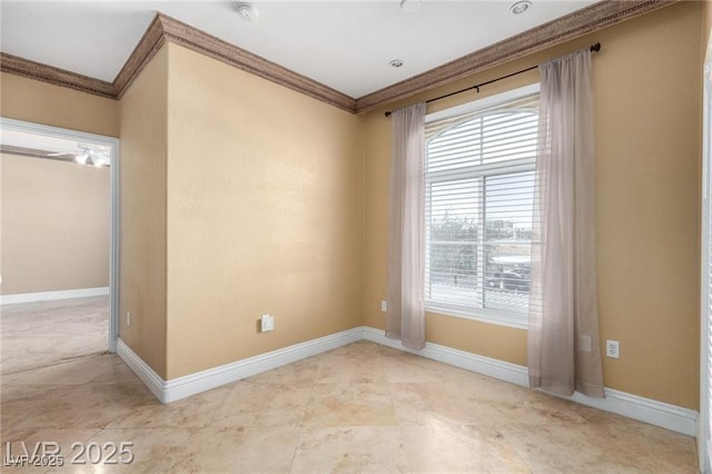 empty room with a healthy amount of sunlight, baseboards, and ornamental molding