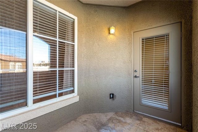 property entrance featuring stucco siding