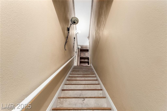 stairway with a textured wall