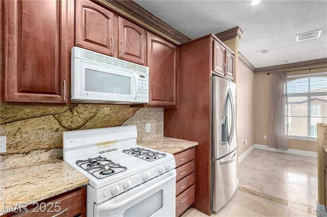 kitchen with light stone counters, crown molding, tasteful backsplash, visible vents, and white appliances